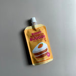 peanut butter pouch for dogs in a carrot cake flavor in an orange and yellow pouch with a carrot cake design